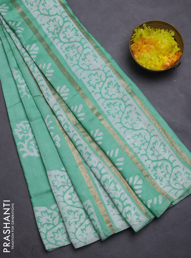 Semi chanderi saree teal green with allover zari strips & batik butta prints in borderless style