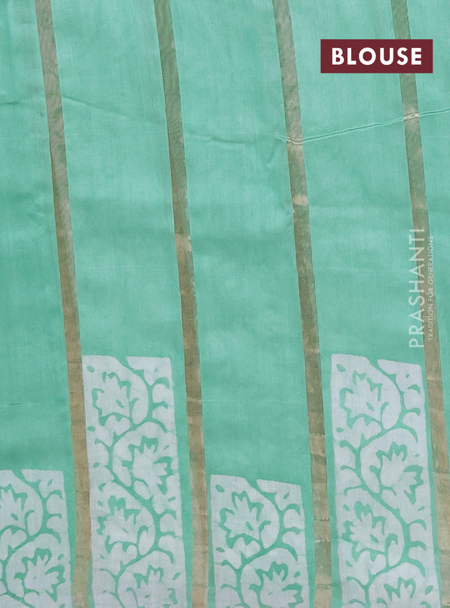 Semi chanderi saree teal green with allover zari strips & batik butta prints in borderless style