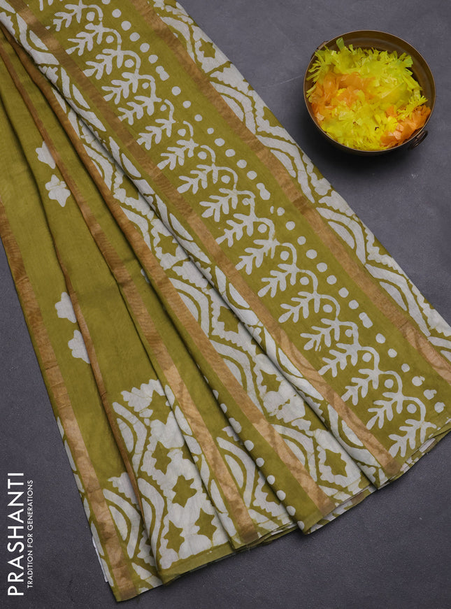 Semi chanderi saree mehendi green with allover zari strips & batik butta prints in borderless style