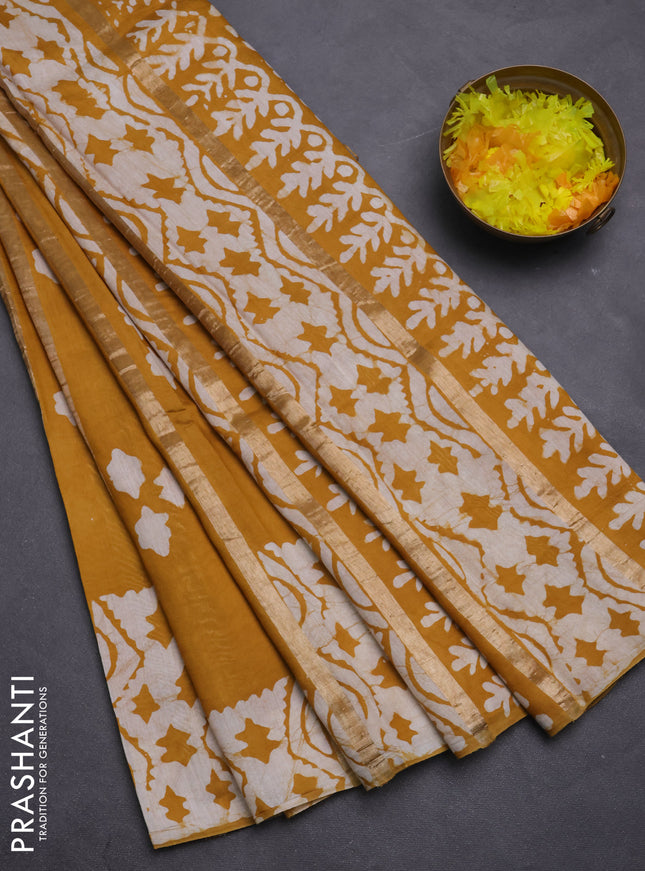 Semi chanderi saree mustard yellow with allover zari strips & batik butta prints in borderless style