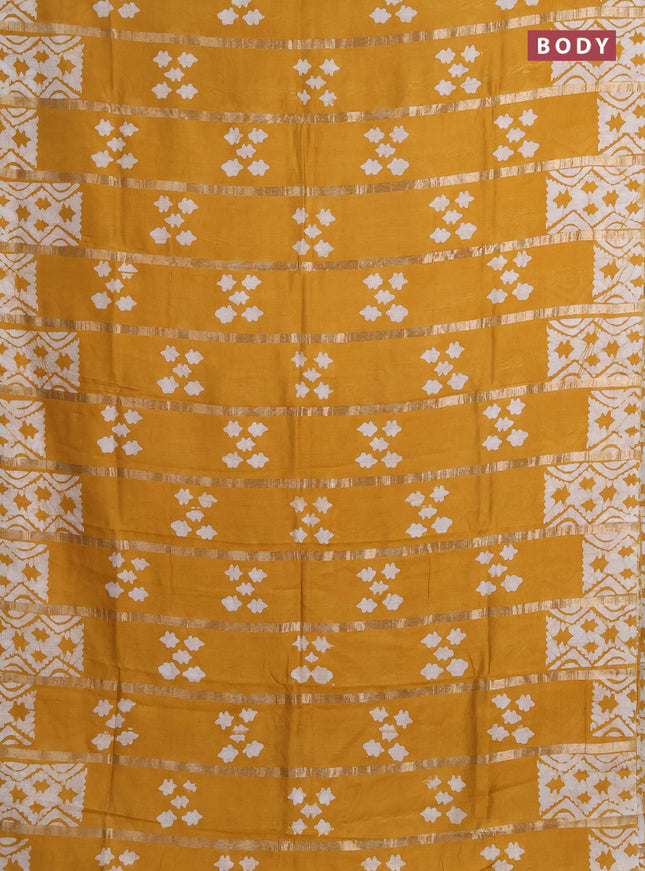 Semi chanderi saree mustard yellow with allover zari strips & batik butta prints in borderless style