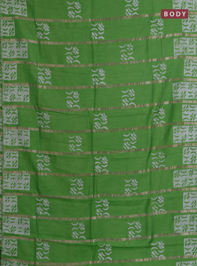 Semi chanderi saree parrot green with allover zari strips & batik butta prints in borderless style