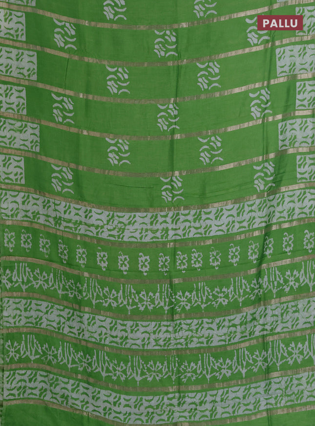 Semi chanderi saree parrot green with allover zari strips & batik butta prints in borderless style