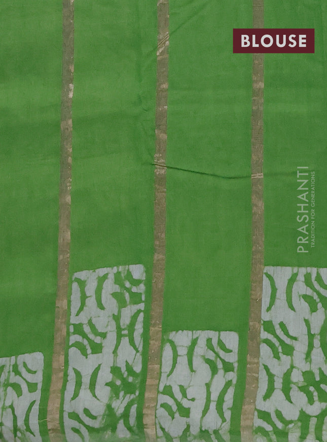 Semi chanderi saree parrot green with allover zari strips & batik butta prints in borderless style