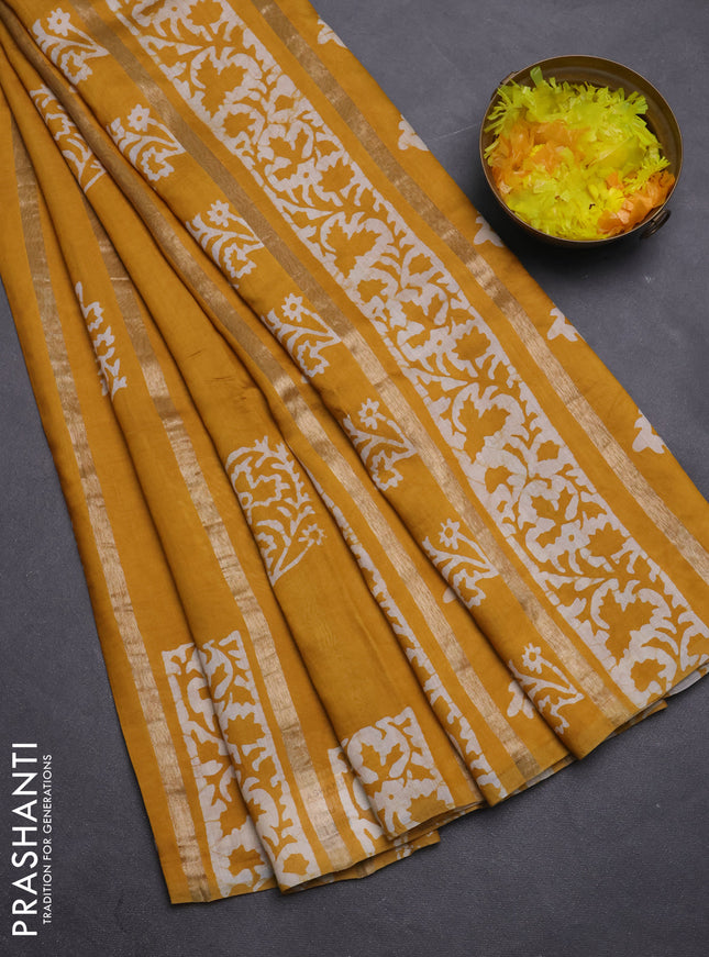 Semi chanderi saree mustard yellow with allover zari strips & batik butta prints in borderless style