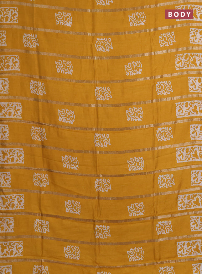 Semi chanderi saree mustard yellow with allover zari strips & batik butta prints in borderless style