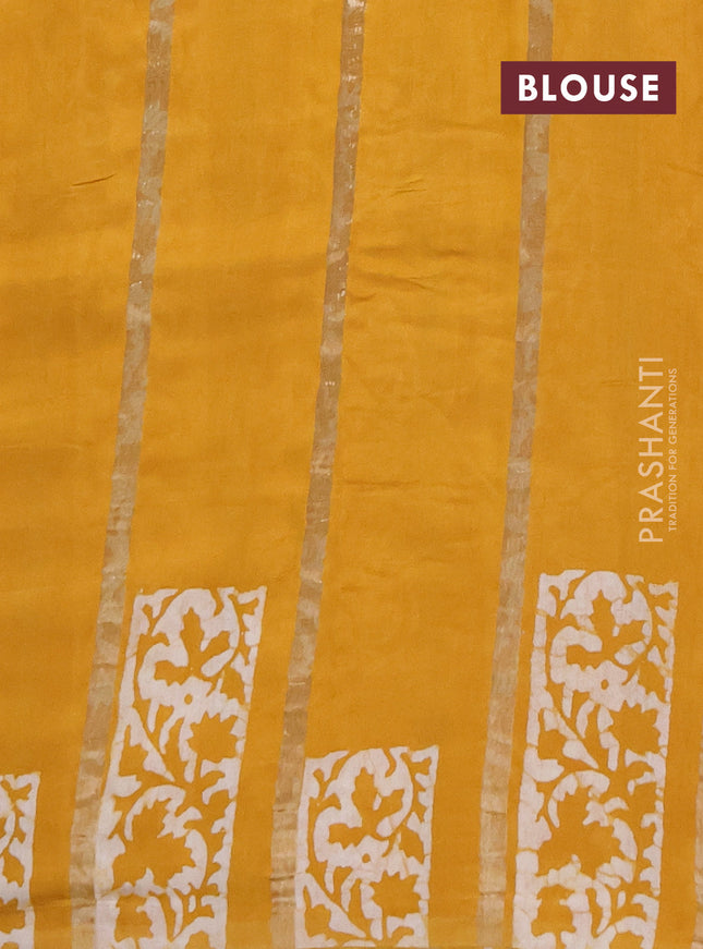 Semi chanderi saree mustard yellow with allover zari strips & batik butta prints in borderless style