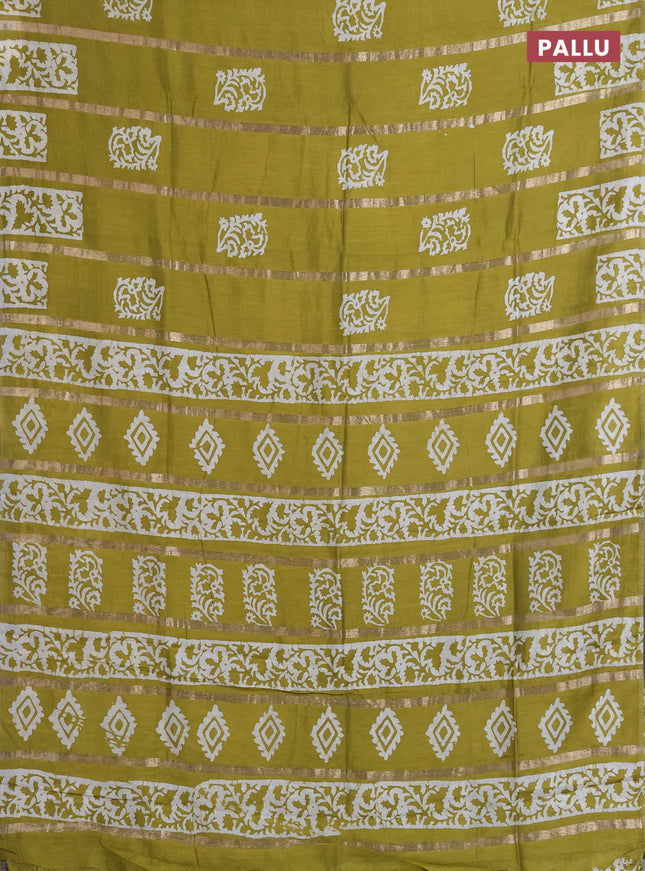 Semi chanderi saree mehendi green with allover zari strips & batik butta prints in borderless style