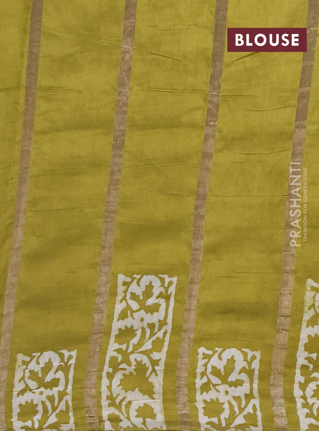 Semi chanderi saree mehendi green with allover zari strips & batik butta prints in borderless style