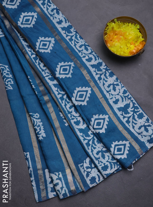 Semi chanderi saree peacock blue with allover zari strips & batik butta prints in borderless style