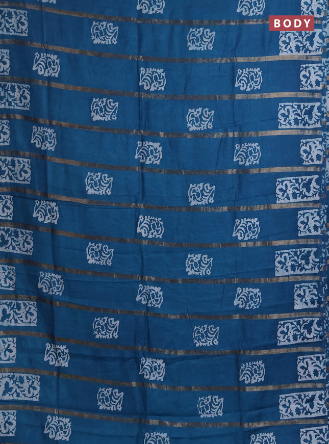 Semi chanderi saree peacock blue with allover zari strips & batik butta prints in borderless style