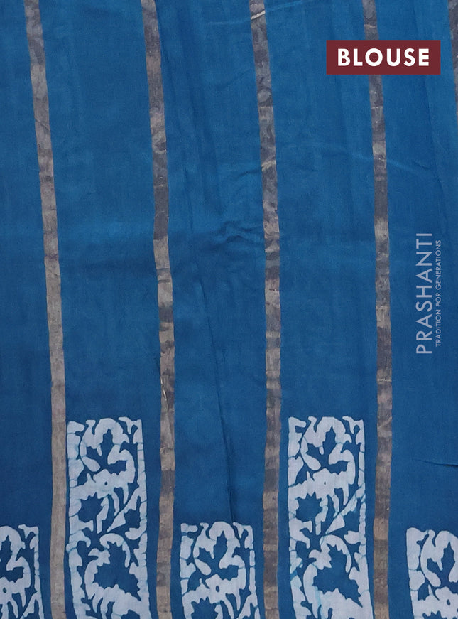 Semi chanderi saree peacock blue with allover zari strips & batik butta prints in borderless style