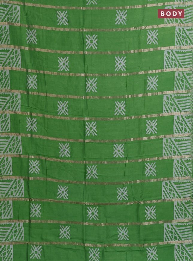 Semi chanderi saree parrot green with allover zari strips & batik butta prints in borderless style