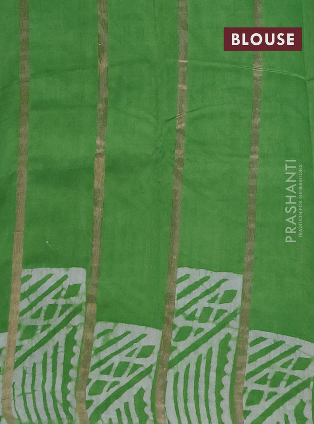 Semi chanderi saree parrot green with allover zari strips & batik butta prints in borderless style