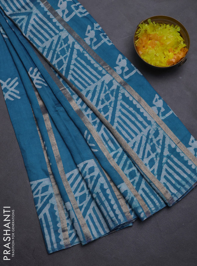 Semi chanderi saree cs blue with allover zari strips & batik butta prints in borderless style