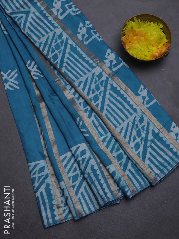 Semi chanderi saree cs blue with allover zari strips & batik butta prints in borderless style
