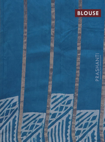 Semi chanderi saree cs blue with allover zari strips & batik butta prints in borderless style