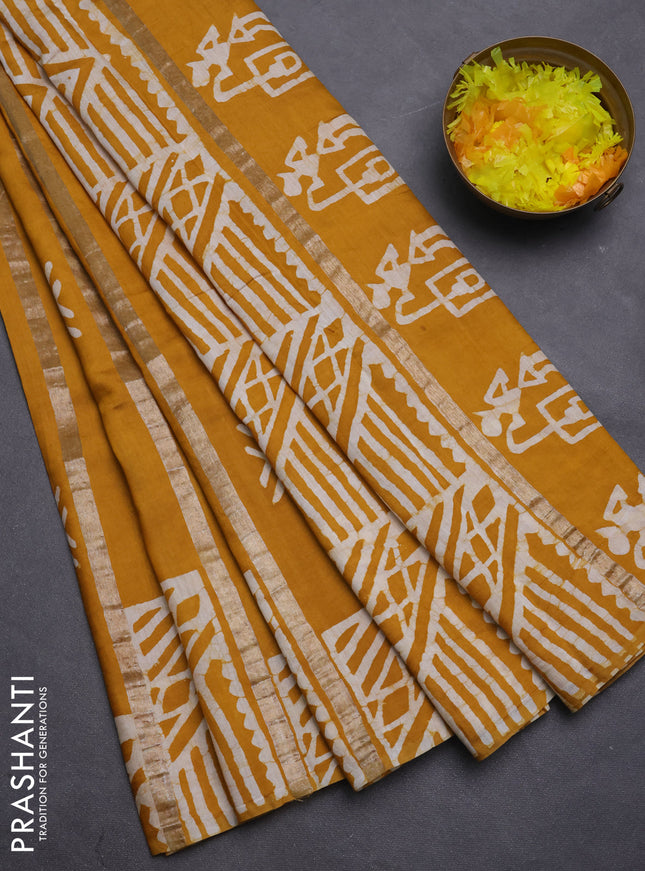 Semi chanderi saree mustard yellow with allover zari strips & batik butta prints in borderless style