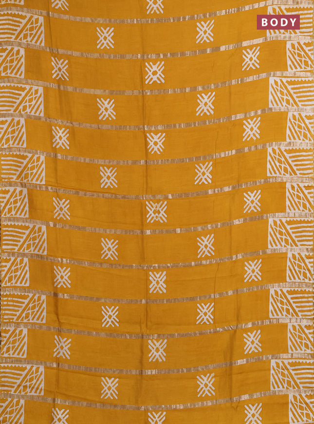 Semi chanderi saree mustard yellow with allover zari strips & batik butta prints in borderless style