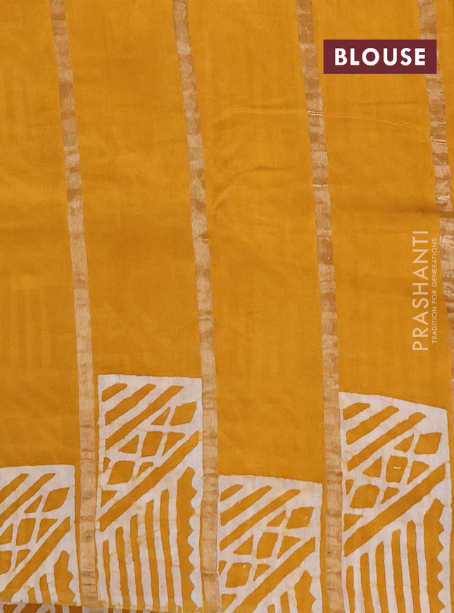 Semi chanderi saree mustard yellow with allover zari strips & batik butta prints in borderless style