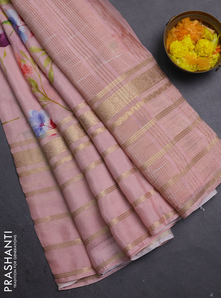 Semi georgette saree peach shade with allover floral prints and long zari woven border