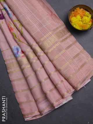 Semi georgette saree peach shade with allover floral prints and long zari woven border