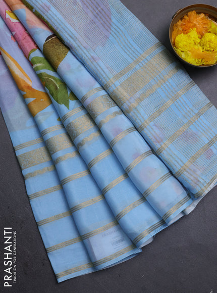 Semi georgette saree blue shade with allover floral prints and long zari woven border