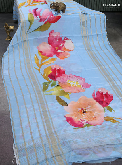 Semi georgette saree blue shade with allover floral prints and long zari woven border