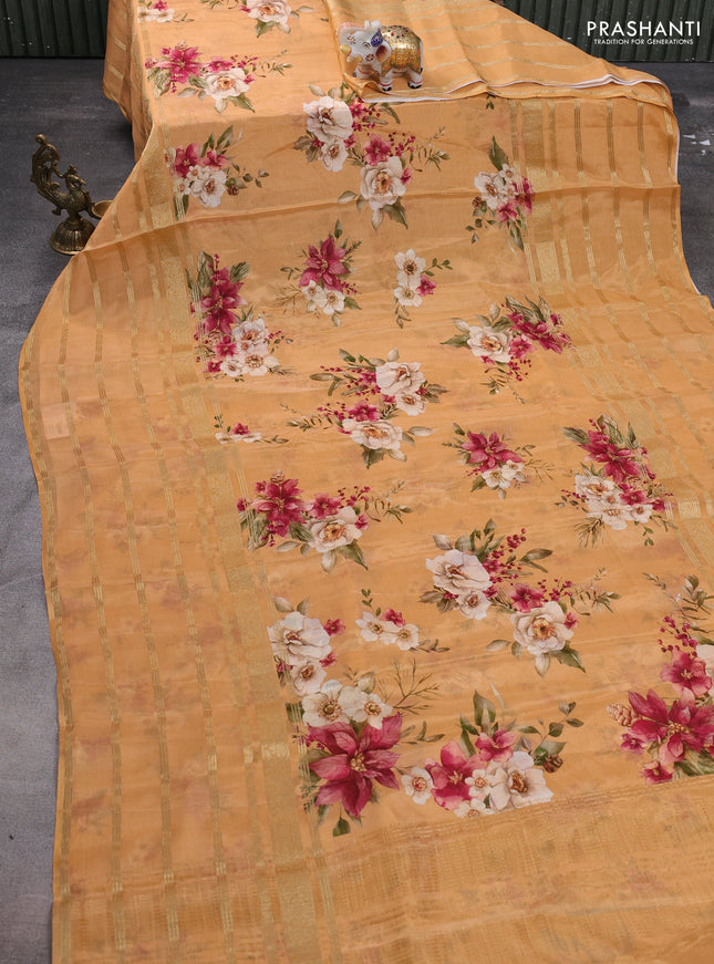 Semi georgette saree orange with allover floral prints and long zari woven border
