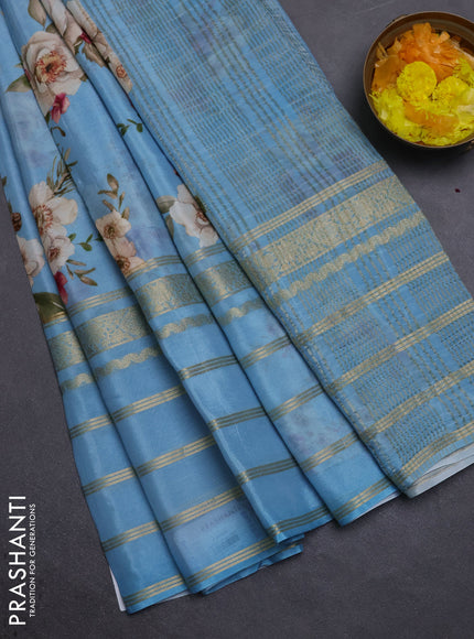 Semi georgette saree blue shade with allover floral prints and long zari woven border