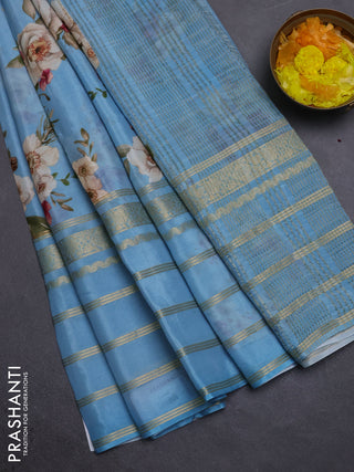 Semi georgette saree blue shade with allover floral prints and long zari woven border