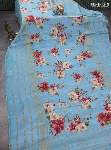 Semi georgette saree blue shade with allover floral prints and long zari woven border