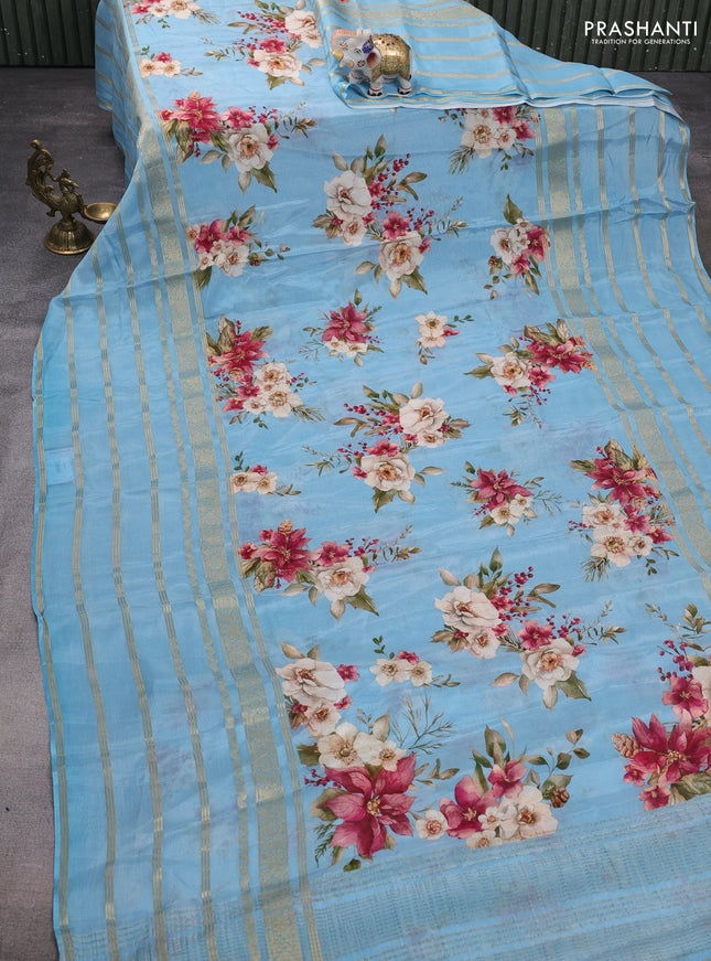 Semi georgette saree blue shade with allover floral prints and long zari woven border