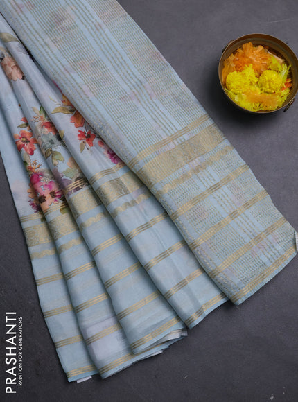 Semi georgette saree pastel blue with allover floral prints and long zari woven border