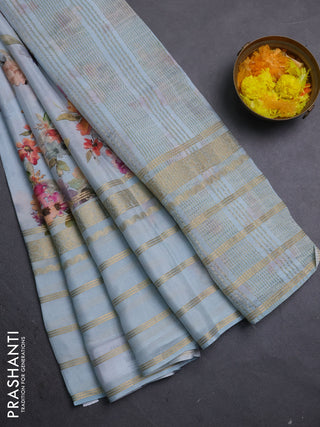 Semi georgette saree pastel blue with allover floral prints and long zari woven border