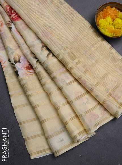 Semi georgette saree pale yellow with allover floral prints and long zari woven border