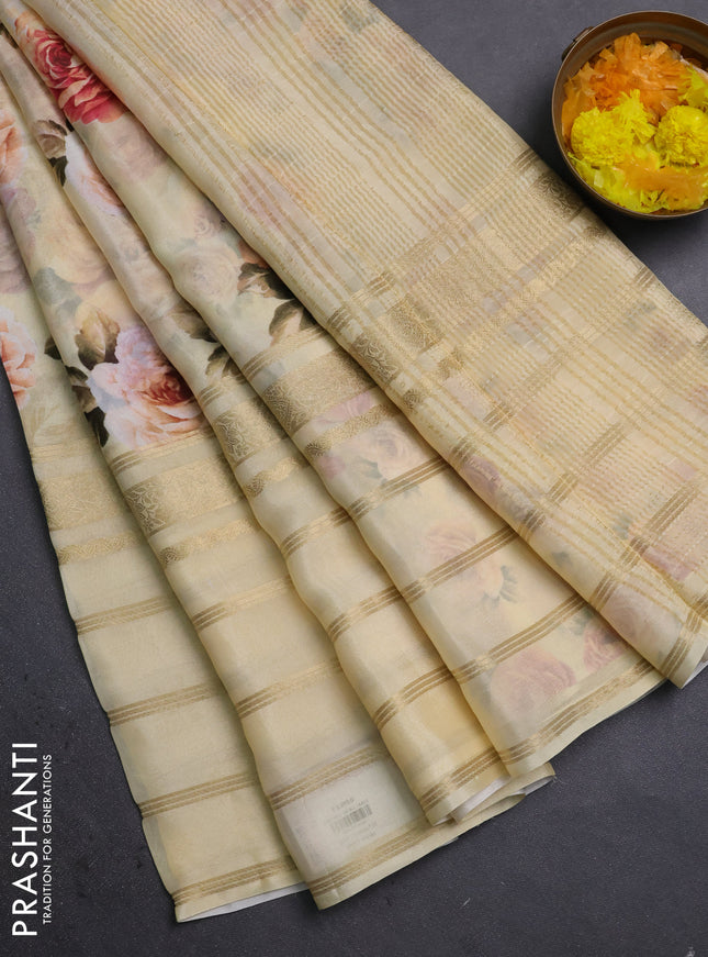 Semi georgette saree pale yellow with allover floral prints and long zari woven border