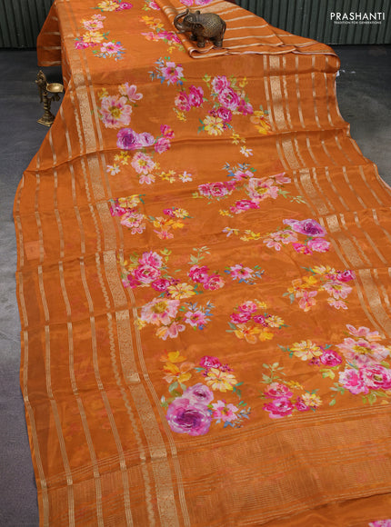 Semi georgette saree rustic orange with allover floral prints and long zari woven border