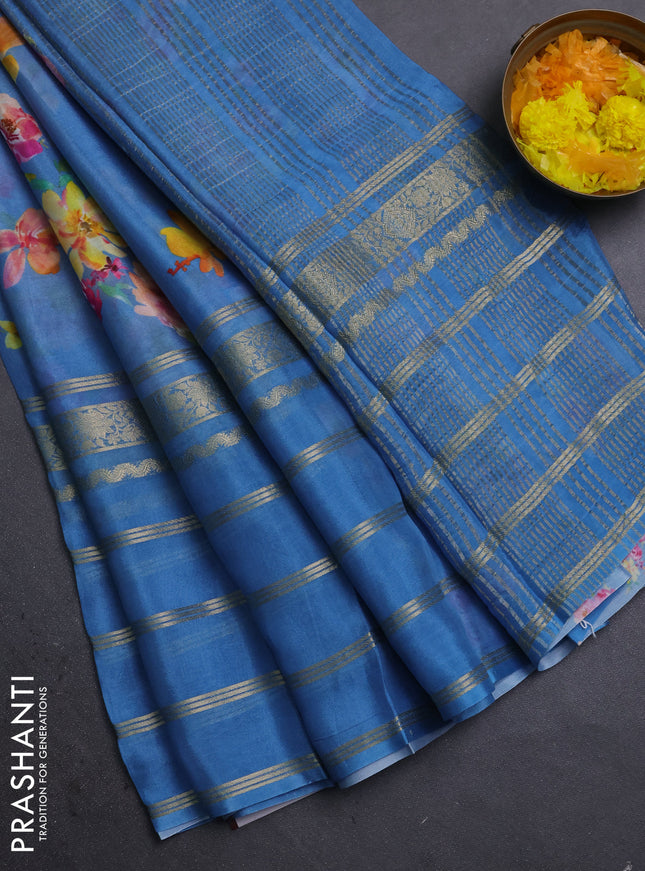 Semi georgette saree blue with allover floral prints and long zari woven border