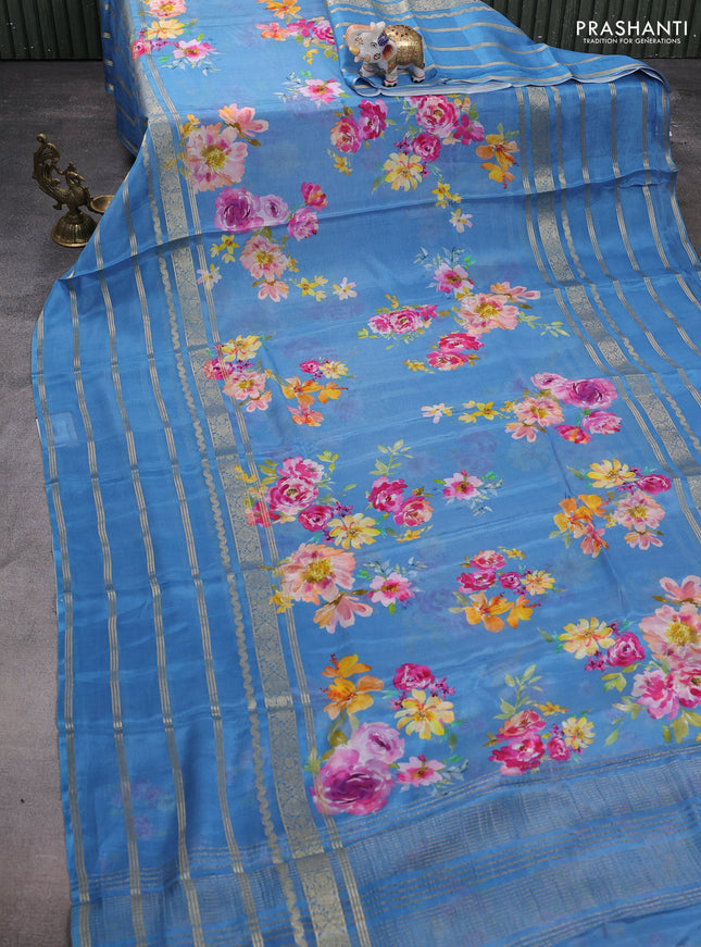 Semi georgette saree blue with allover floral prints and long zari woven border