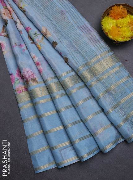 Semi georgette saree pastel blue with allover floral prints and long zari woven border