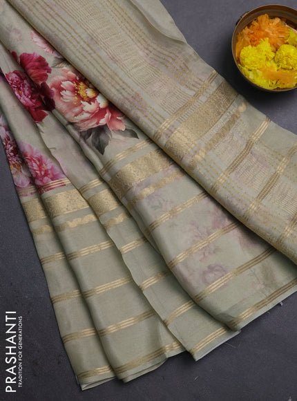 Semi georgette saree elaichi green with allover floral prints and long zari woven border