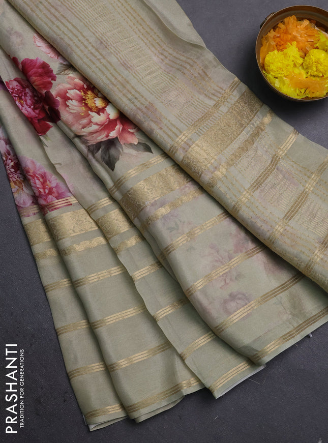 Semi georgette saree elaichi green with allover floral prints and long zari woven border