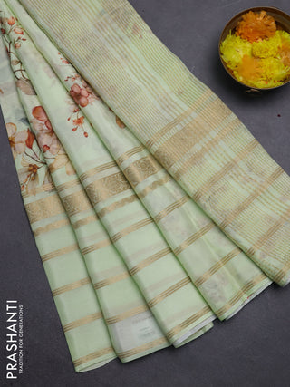 Semi georgette saree pista green with allover floral prints and long zari woven border