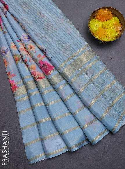 Semi georgette saree pastel blue with allover floral prints and long zari woven border