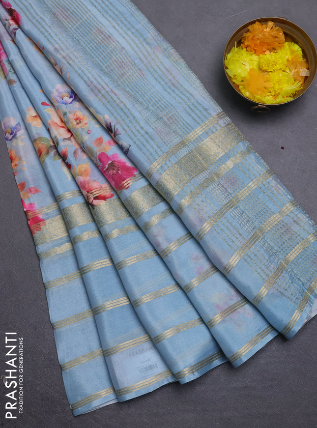 Semi georgette saree pastel blue with allover floral prints and long zari woven border