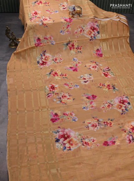 Semi georgette saree pale orange shade with allover floral prints and long zari woven border