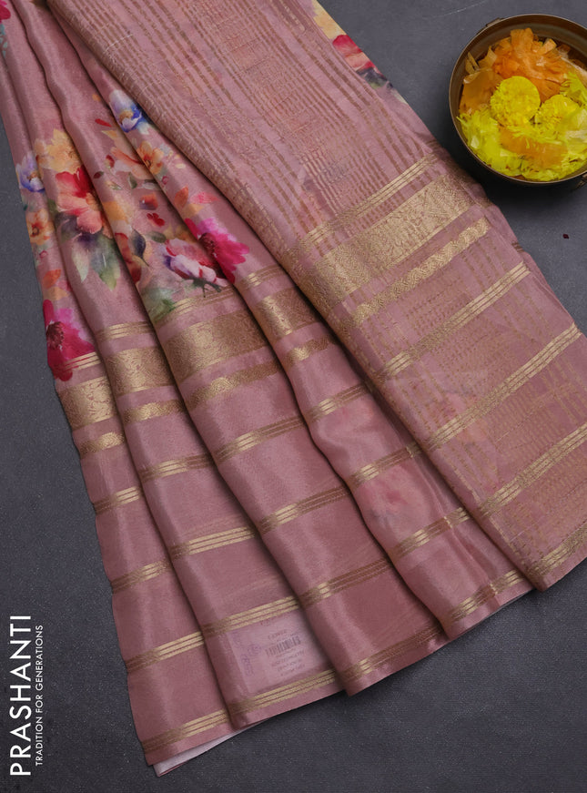 Semi georgette saree pastel peach shade with allover floral prints and long zari woven border