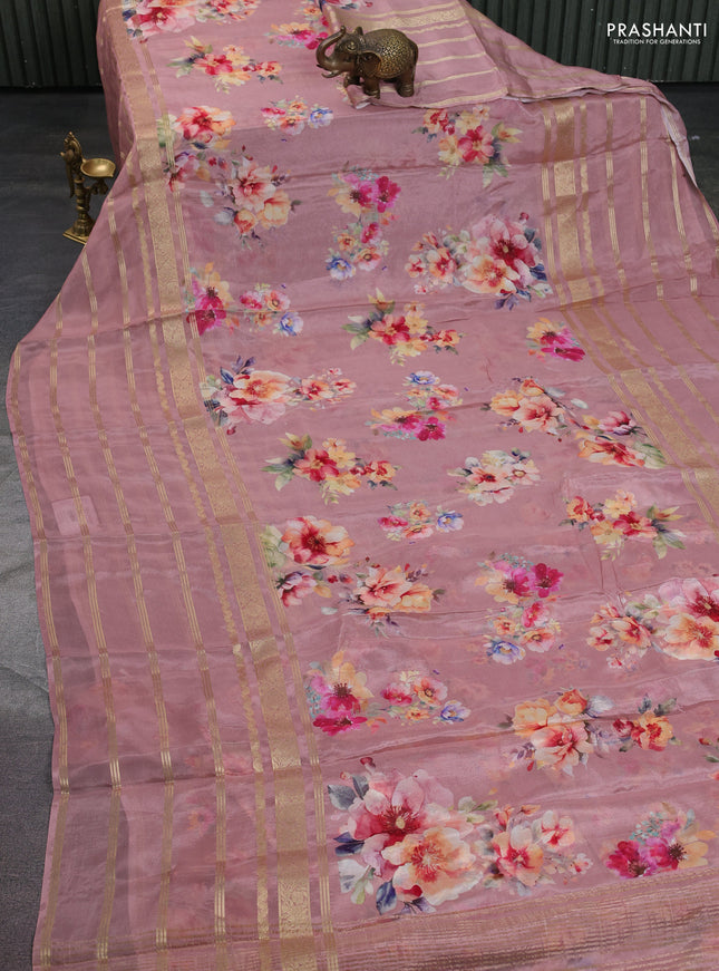 Semi georgette saree pastel peach shade with allover floral prints and long zari woven border