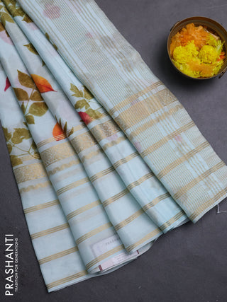 Semi georgette saree teal blue with allover floral prints and long zari woven border
